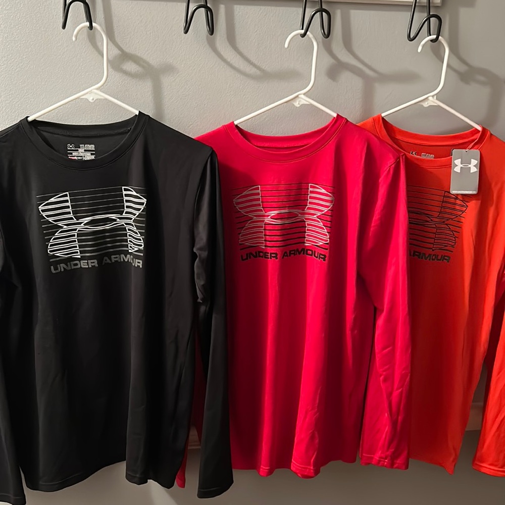 Four Under Amour and one Adidas long sleeve shirts. All youth XL.
